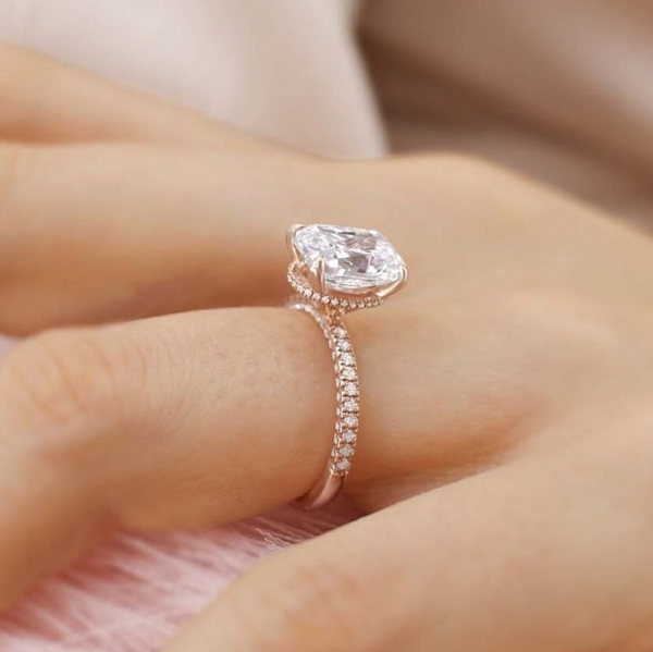 hand wearing lab diamond hidden halo triple pave engagement ring 18k rose gold