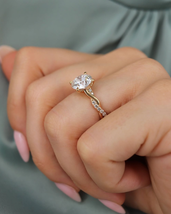 hand wearing lily arkwright eden 18k yellow gold twisted band engagement ring