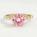 Allure solitaire engagement ring in 18k yellow gold with a round morganite-pink lab-grown sapphire centre stone, front view.