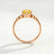 Alya starburst cluster engagement ring in 18k rose gold with a round yellow lab-grown sapphire centre stone, side profile showing the setting and band.