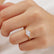 Round gemstone engagement ring, worn on a model's hand.