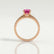Catalina solitaire engagement ring in 18k rose gold with a round pink lab-grown sapphire centre stone, side profile showing the setting and band.
