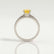 Catalina solitaire engagement ring with a round yellow lab-grown sapphire centre stone, side profile showing the setting and band.