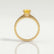 Catalina solitaire engagement ring in 18k yellow gold with a round yellow lab-grown sapphire centre stone, side profile showing the setting and band.