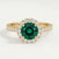 Cecily halo engagement ring in 18k yellow gold with a round lab-grown emerald centre stone and diamond accents, front view.