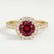 Cecily halo engagement ring in 18k yellow gold with a round lab-grown ruby centre stone and diamond accents, front view.