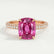 Coco hidden halo engagement ring in 18k rose gold with an elongated cushion pink lab-grown sapphire centre stone on a triple pavé band, front view.