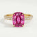 Coco hidden halo engagement ring in 18k yellow gold with an elongated cushion pink lab-grown sapphire centre stone on a triple pavé band, front view.