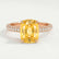 Coco hidden halo engagement ring in 18k rose gold with an elongated cushion yellow lab-grown sapphire centre stone on a triple pavé band, front view.