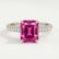 Coco hidden halo engagement ring with a radiant pink lab-grown sapphire centre stone and diamond accents on a triple pavé band, front view.