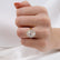 Oval gemstone engagement ring, worn on a model's hand.