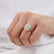 Oval gemstone engagement ring, worn on a model's hand.