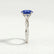 Eden vine solitaire engagement ring with an oval blue lab-grown sapphire centre stone and diamond accents, end-on view showing the setting and band.