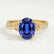 Eden vine solitaire engagement ring in 18k yellow gold with an oval blue lab-grown sapphire centre stone and diamond accents, front view.
