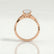 Eden vine solitaire engagement ring in 18k rose gold with an oval moissanite centre stone and diamond accents, side profile showing the setting and band.
