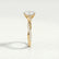 Eden vine solitaire engagement ring in 18k yellow gold with an oval moissanite centre stone and diamond accents, end-on view showing the setting and band.