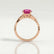 Eden vine solitaire engagement ring in 18k rose gold with an oval pink lab-grown sapphire centre stone and diamond accents, side profile showing the setting and band.