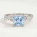Eden vine solitaire engagement ring with a princess-cut aquamarine-blue lab-grown sapphire centre stone and diamond accents, front view.