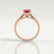 Elena solitaire engagement ring in 18k rose gold with a round pink lab-grown sapphire centre stone, side profile showing the setting and band.