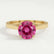 Elena solitaire engagement ring in 18k yellow gold with a round pink lab-grown sapphire centre stone, front view.