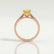 Elena solitaire engagement ring in 18k rose gold with a round yellow lab-grown sapphire centre stone, side profile showing the setting and band.