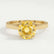 Elena solitaire engagement ring in 18k yellow gold with a round yellow lab-grown sapphire centre stone, front view.