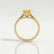 Elena solitaire engagement ring in 18k yellow gold with a round yellow lab-grown sapphire centre stone, side profile showing the setting and band.