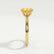 Elena solitaire engagement ring in 18k yellow gold with a round yellow lab-grown sapphire centre stone, end-on view showing the setting and band.