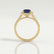 Esme halo engagement ring in 18k yellow gold with an emerald-cut lab-grown alexandrite centre stone and diamond accents, side profile showing the setting and band.
