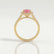 Esme halo engagement ring in 18k yellow gold with an emerald-cut morganite-pink lab-grown sapphire centre stone and diamond accents, side profile showing the setting and band.