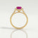Esme halo engagement ring in 18k yellow gold with an emerald-cut pink lab-grown sapphire centre stone and diamond accents, side profile showing the setting and band.