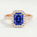 Esme halo engagement ring in 18k rose gold with a radiant blue lab-grown sapphire centre stone and diamond accents, front view.