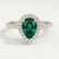 Harlow halo engagement ring in platinum with a pear-shaped lab-grown emerald centre stone and diamond accents, front view.