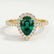 Harlow halo engagement ring in 18k yellow gold with a pear-shaped lab-grown emerald centre stone and diamond accents, front view.