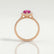 Harlow halo engagement ring in 18k rose gold with a pear-shaped pink lab-grown sapphire centre stone and diamond accents, side profile showing the setting and band.