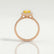 Harlow halo engagement ring in 18k rose gold with a pear-shaped yellow lab-grown sapphire centre stone and diamond accents, side profile showing the setting and band.