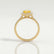 Harlow halo engagement ring in 18k yellow gold with a pear-shaped yellow lab-grown sapphire centre stone and diamond accents, side profile showing the setting and band.