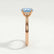 Isabella solitaire engagement ring in 18k rose gold with an oval aquamarine-blue lab-grown sapphire centre stone, side profile showing the setting and band.