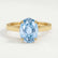 Isabella solitaire engagement ring in 18k yellow gold with an oval aquamarine-blue lab-grown sapphire centre stone, front view.
