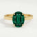 Isabella solitaire engagement ring in 18k yellow gold with an oval lab-grown emerald centre stone, front view.