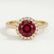 Lavender halo engagement ring in 18k yellow gold with a round lab-grown ruby centre stone and diamond accents, front view.