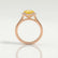 Lavender halo engagement ring in 18k rose gold with a round yellow lab-grown sapphire centre stone and diamond accents, side profile showing the setting and band.