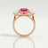 Leanora trilogy engagement ring in 18k rose gold with a round pink lab-grown sapphire centre stone, side profile showing the setting and band.