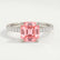 Lively hidden halo engagement ring with a cushion morganite-pink lab-grown sapphire centre stone on a pavé-set band, front view.