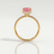 Lively hidden halo engagement ring in 18k yellow gold with an emerald-cut morganite-pink lab-grown sapphire centre stone and diamond accents on a pavé-set band, side profile showing the setting and band.