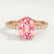 Lively hidden halo engagement ring in 18k rose gold with an oval morganite-pink lab-grown sapphire centre stone on a pavé-set band, front view.