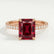 Lively hidden halo engagement ring in 18k rose gold with a radiant lab-grown ruby centre stone and diamond accents on a pavé-set band, front view.