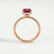 Lively hidden halo engagement ring in 18k rose gold with a radiant lab-grown ruby centre stone and diamond accents on a pavé-set band, side profile showing the setting and band.