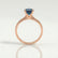 Lottie solitaire engagement ring in 18k rose gold with a round lab-grown alexandrite centre stone, side profile showing the setting and band.