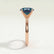 Lulu solitaire engagement ring in 18k rose gold with an elongated cushion lab-grown alexandrite centre stone, end-on view showing the setting and band.